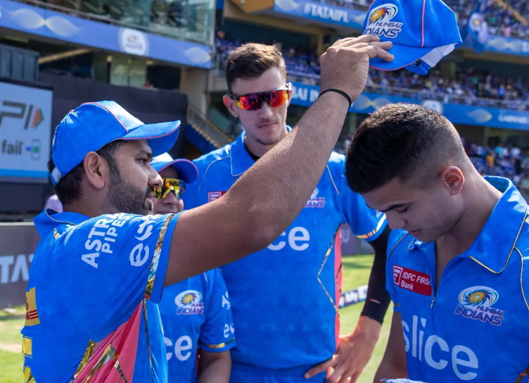 Капитан MI Рохит Шарма (Rohit Sharma) вручает кепку игрока Арджуну Тендулкару (Arjun Tendulkar). Фото: IPL